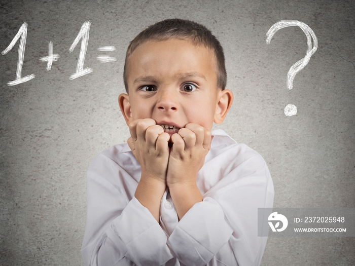 Portrait confused, anxious boy trying to solve math problem