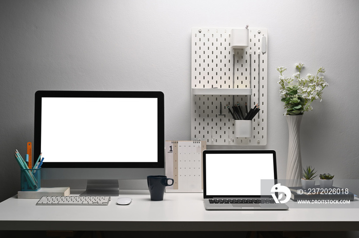 创意工作空间上的家庭办公桌、双显示器Pc和笔记本电脑，带有剪辑路径层。