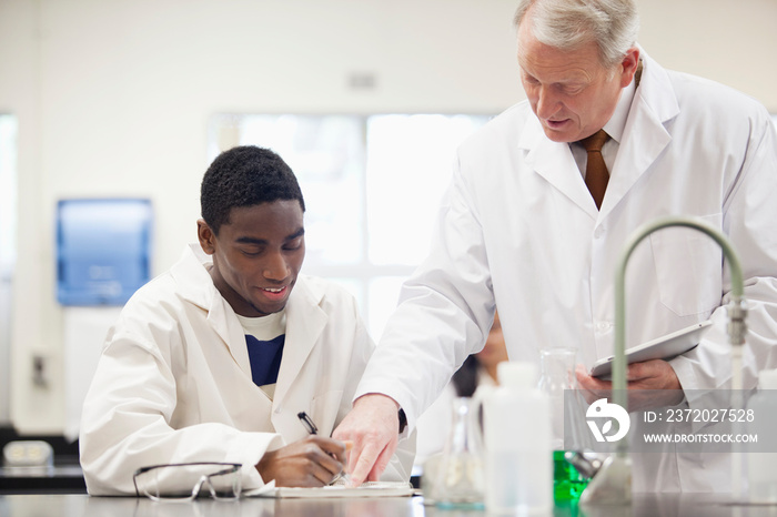 professor helping student in science lab