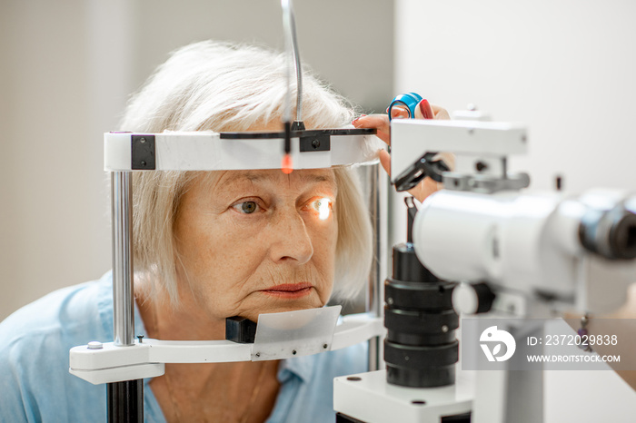 Senior woman during a medical eye examination with microscope in the ophthalmologic office