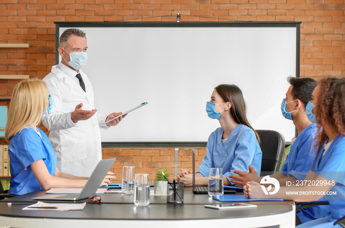 Male lecturer teaching medical students in university