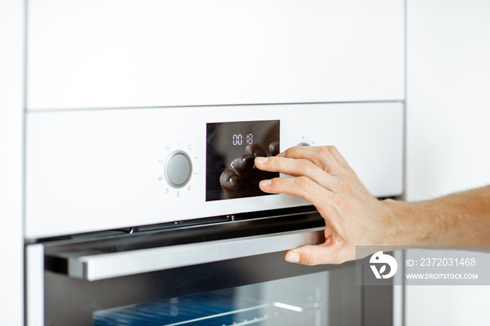 Setting up electric oven on the kitchen at home, close-up view