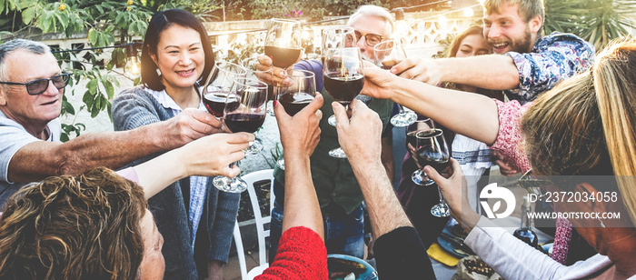 Happy family cheering with red wine at barbecue dinner outdoor - Different age of people having fun 