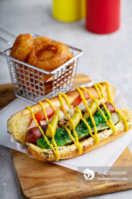 Chicago hot dog on a poppy seed bun topped with tomatoes and sweet relish