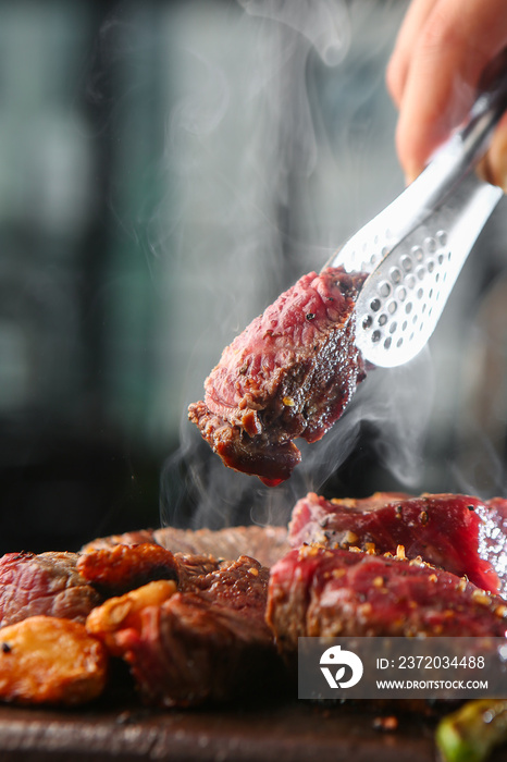 Raw beef dishes being cooked on a fire plate 불판위에 조리되고 있는 생소고기 요리