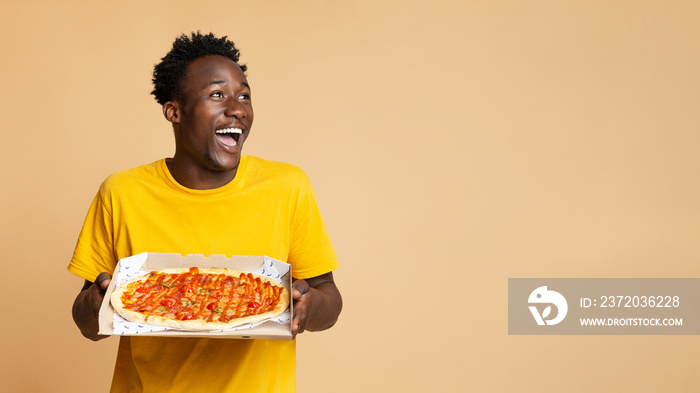 Food Delivery Concept. Excited Black Guy Holding Box With Tasty Italian Pizza