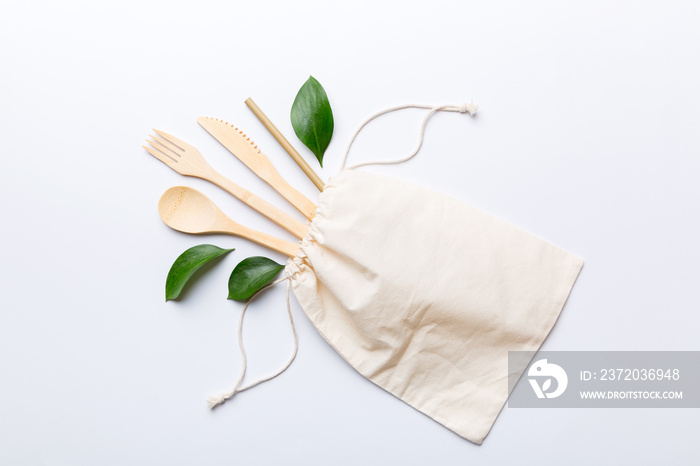 Eco friendly reusable recyclable white eco bag with kitchenware on Colored background. Concept zero 