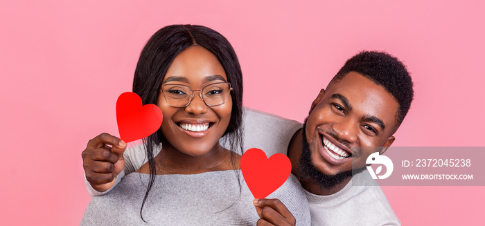 Portrait of black couple in love with heart shaped cards