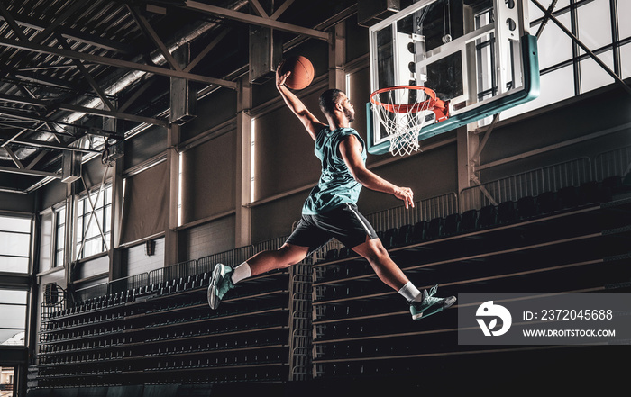 Black professional Black basketball player in action in a basketball court.