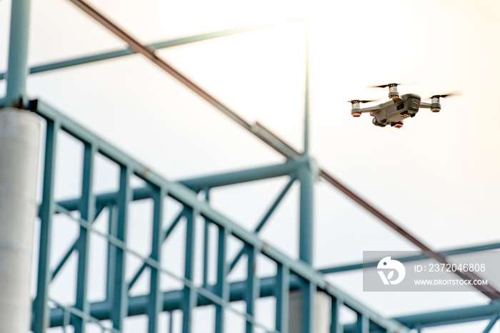 Drone flying over steel structure at construction site. Drone photography for construction industry.