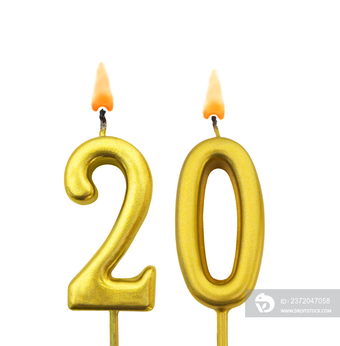 Burning golden birthday candles isolated on white background, number 20