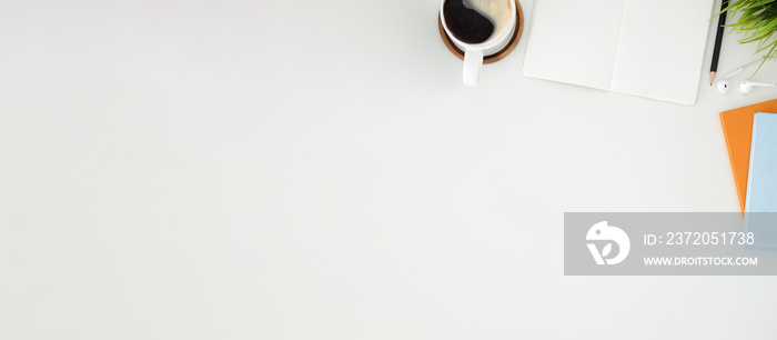 Top view coffee cup, houseplant and empty notebook on white table. Copy space.