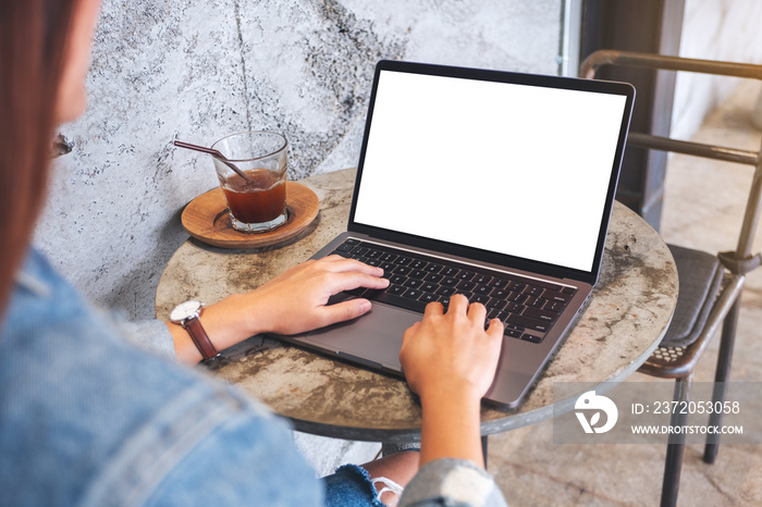 Mockup image of a woman using and typing on laptop computer keyboard with blank white desktop screen