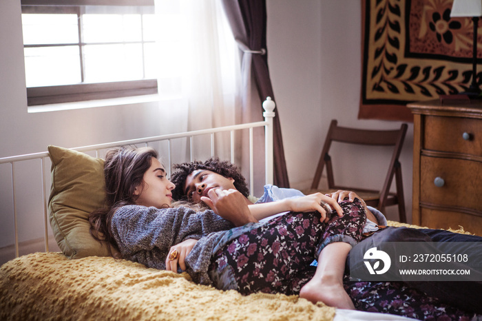 Couple lying in bed at home