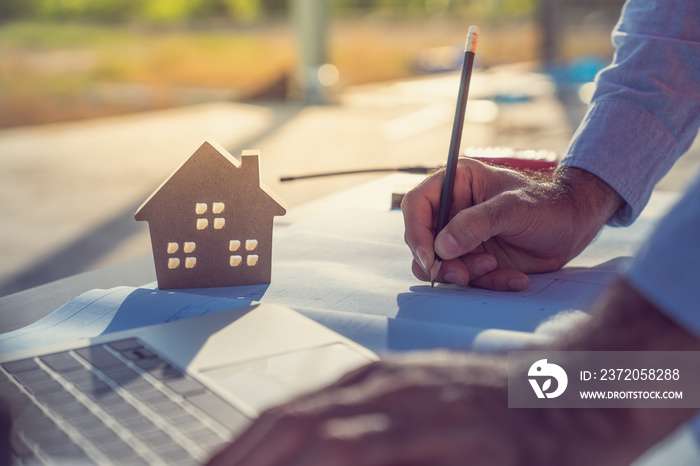 Engineer working on construction site with drawing document