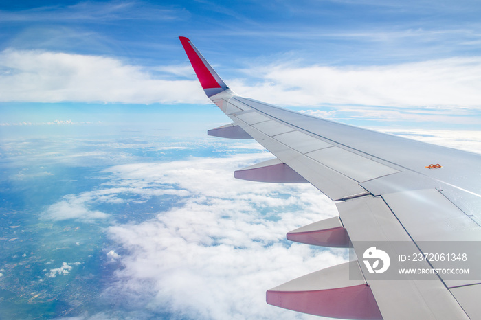 Wing plane with white cloudy and blue sky,