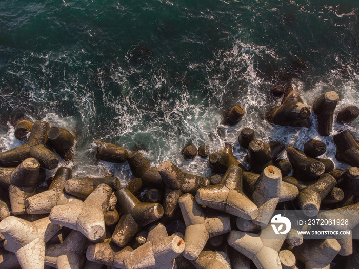 Aerial drone view of a breakwater. breakwater in the sea, a collection of concrete breakers