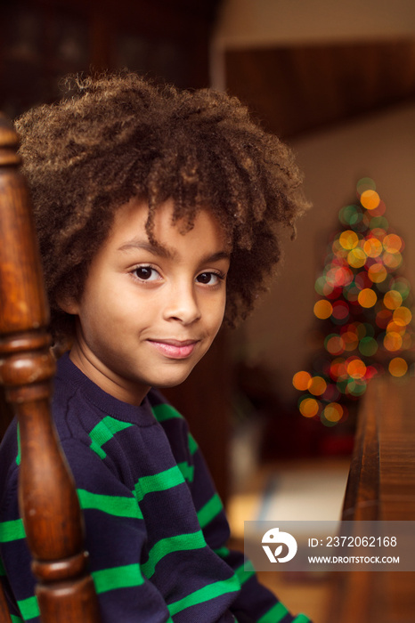 Portrait of boy sitting indoors