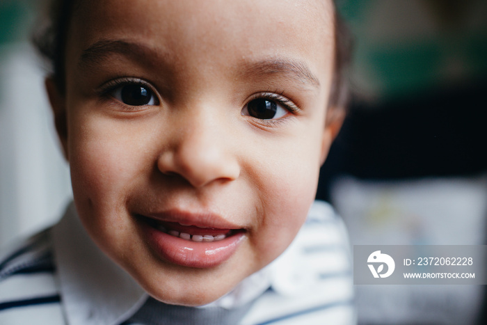 Close-up portrait of cute boy at home