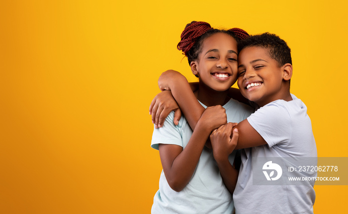 Emotional african american brother and sister embracing and smiling