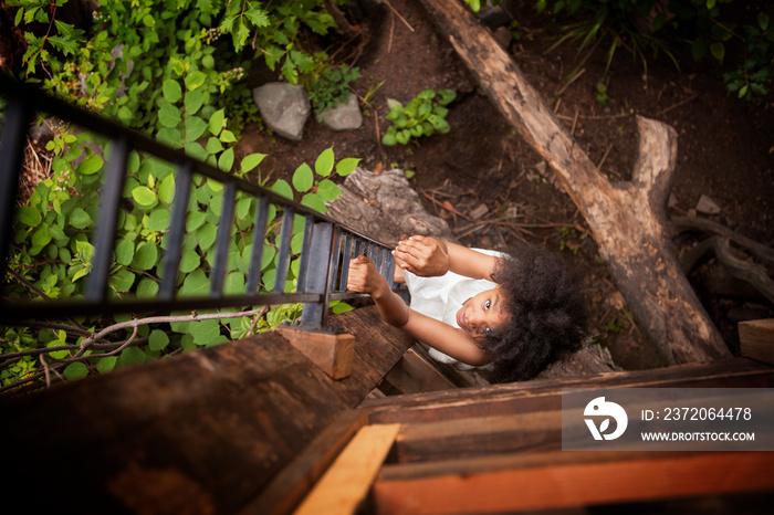 Portrait of girl climbing on ladder