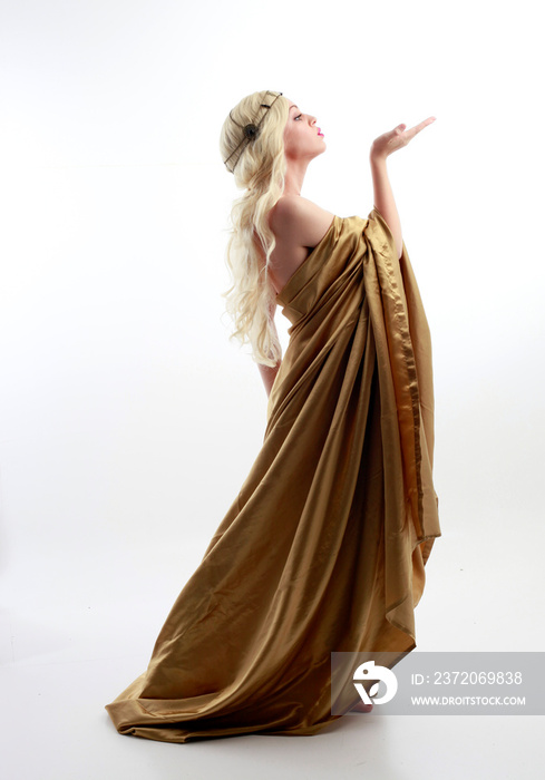 Full length portrait of pretty female model wearing  grecian goddess  toga gown, posing with elegant