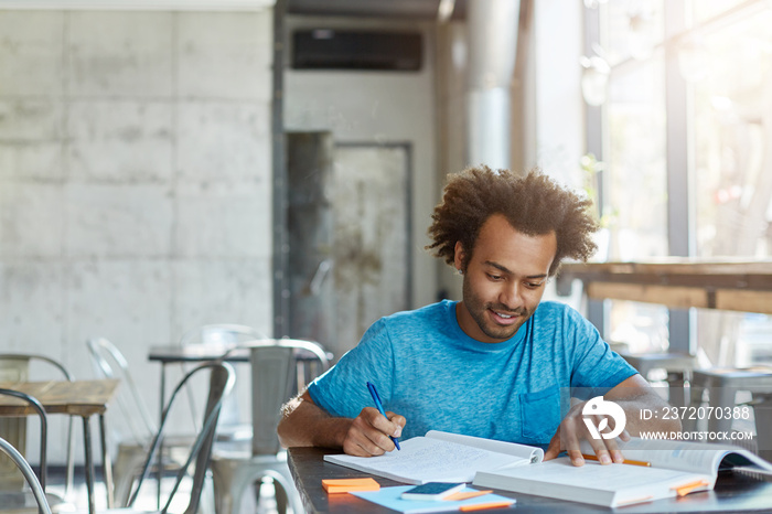 Hardworking excited African American A-student feeling happy after he solved complicated mathematica