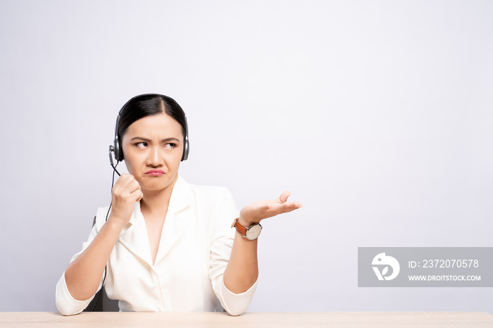 Woman operator in headset feel angry over white background