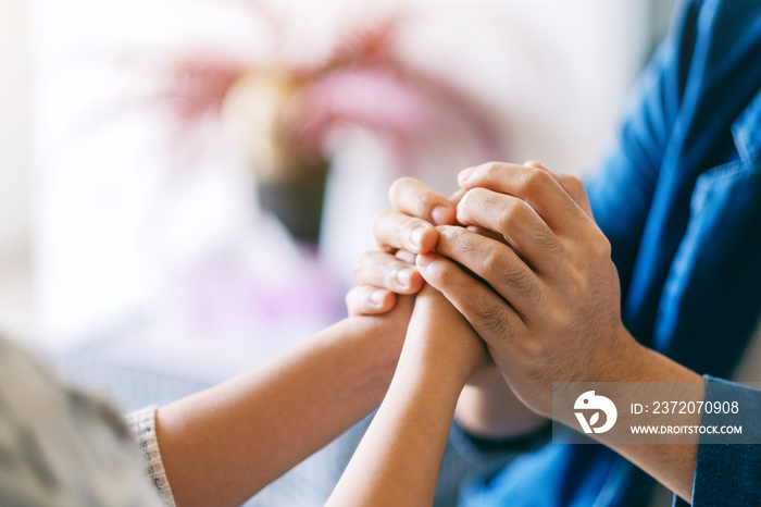 A man holding a womans hands to show love and care