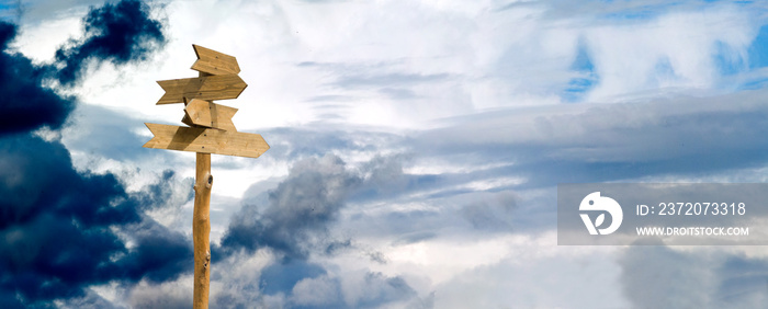 image of wooden signposts against the sky