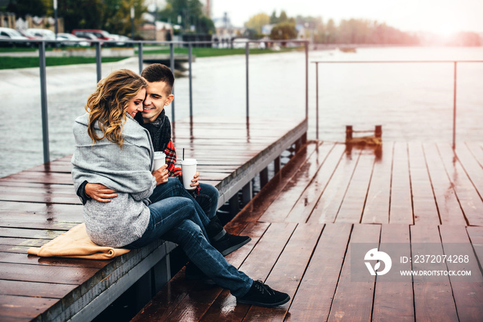 Pretty happy couple drinking hot coffee outdoor