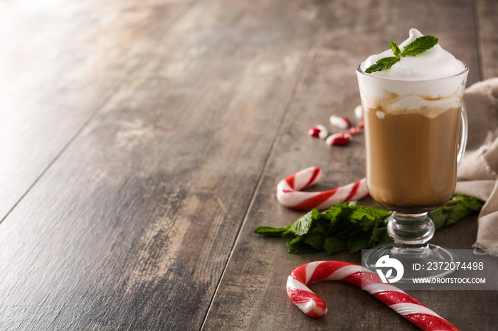 Peppermint coffee mocha for Christmas on wooden table. Copy space