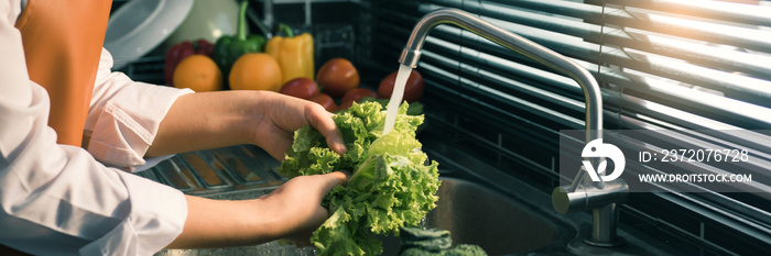 Asian hands woman washing vegetables salad and preparation healthy food in kitchen.