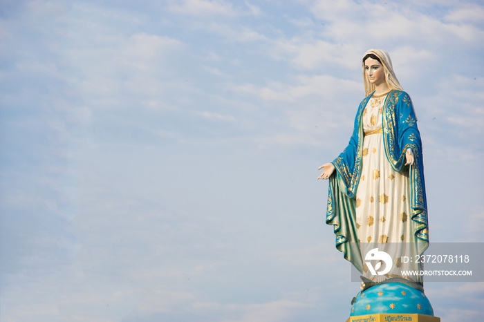 Virgin mary statue with blue sky background