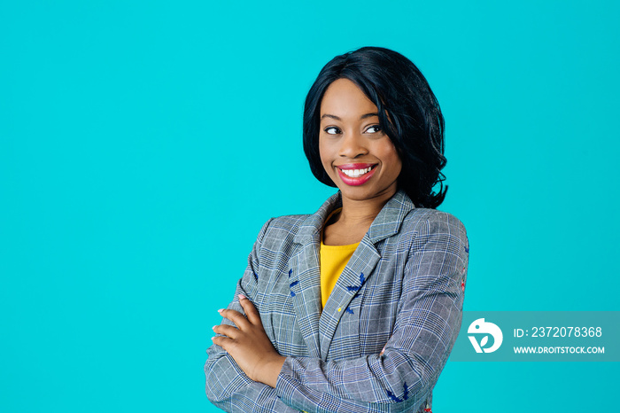 Portrait of a  happy smiling young woman in business jacket with arms crossed looking to side isolat