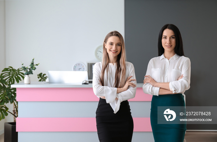 Female receptionists near desk in hotel