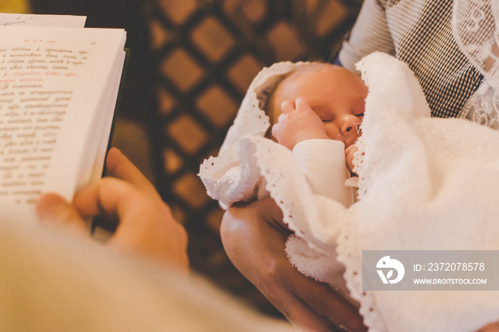 The sacrament of the baptism of a child. Selective focus.