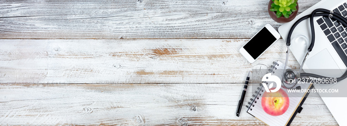 Overhead view of white rustic desk with medical and health care items