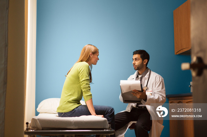 Doctor talking to patient in hospital room