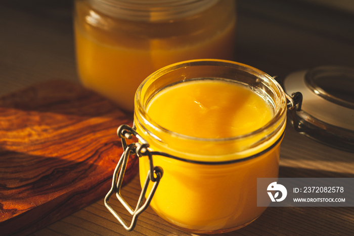 Glass jar with ghee - clarified butter at kitchen