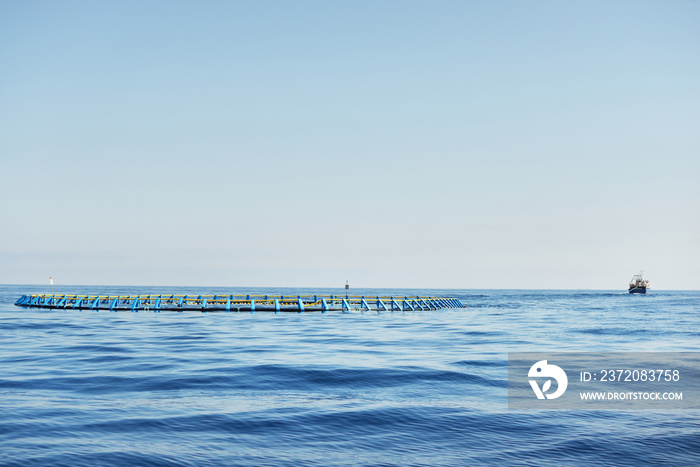 Fish farm in an open Mediterranean sea, fishing boat (small ship) close-up, Spain. Food industry, tr