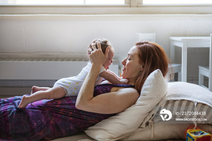 Side view of mother and daughter at home