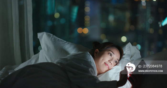 Woman use of mobile phone and read on cellphone at night