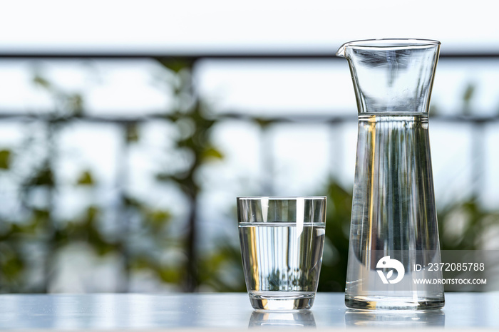 Drink water glass jug with glass on table at garden home