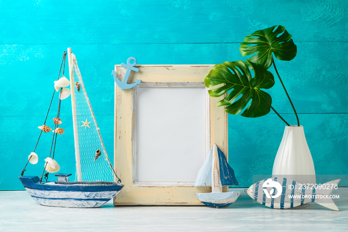 Frame and nautical summer decorations on wooden table