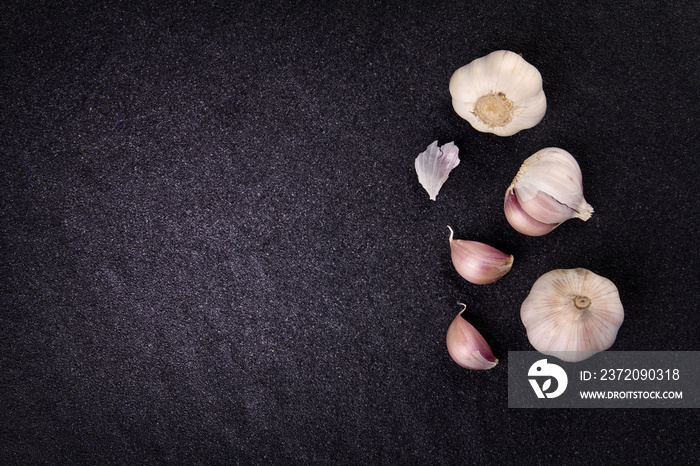 a still life arrangement of Three whole garlic bulbs grouped