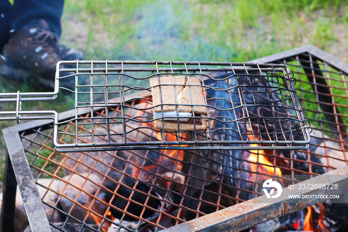 Smored being grilled over an open flame