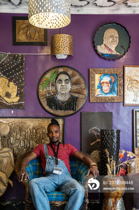 metal artist sitting proudly in his studio