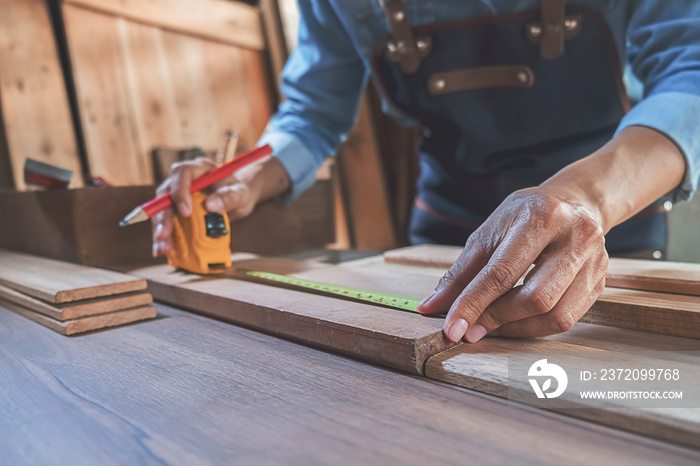 Carpenter working with equipment on wooden table in carpentry shop. woman works in a carpentry shop.