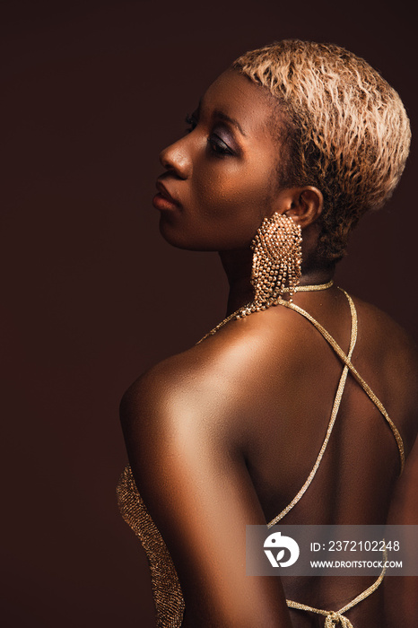 back view of african american woman with short hair isolated on brown